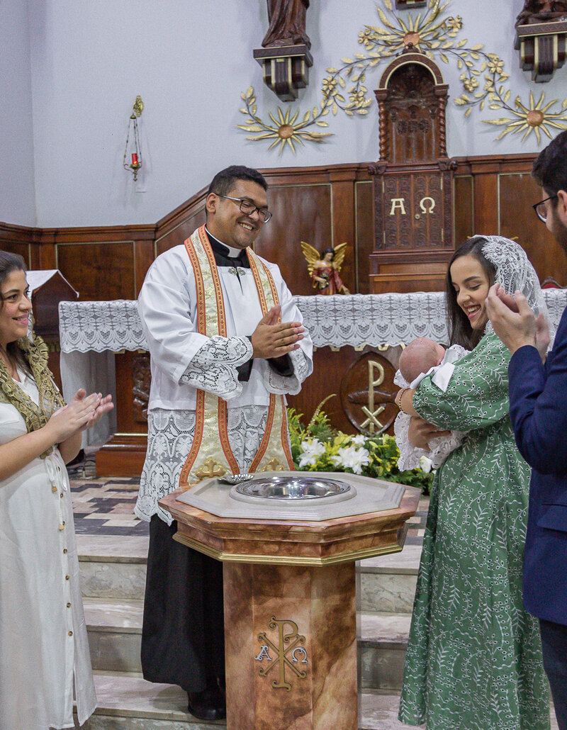 Teresa&rsquo;s baptism in Brazil with Padre Bruno at the font
