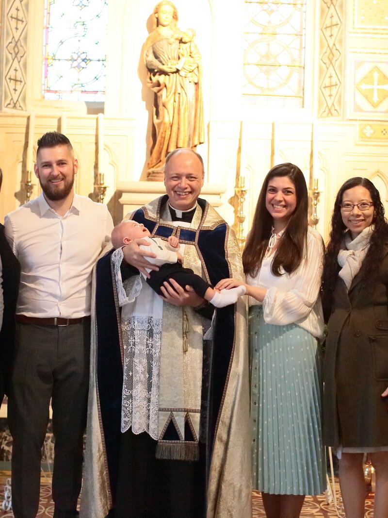 Tom&aacute;s&rsquo;s baptism with godparents Felipe and Aline and Fr. Martin